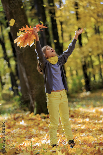 Photo: Autumn fun - lovely girl has a fun in autumn park Autumn fun - lovely girl has a fun in autumn park