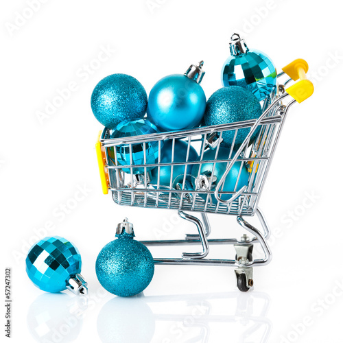 Photo: Shopping cart full of christmas balls isolated on white backgrou Shopping cart full of christmas balls isolated on white backgrou