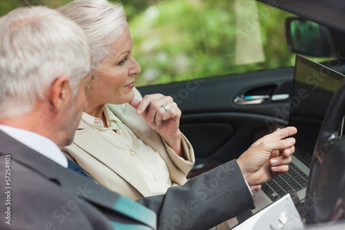 Photo: Business people working together in classy cabriolet Business people working together in classy cabriolet