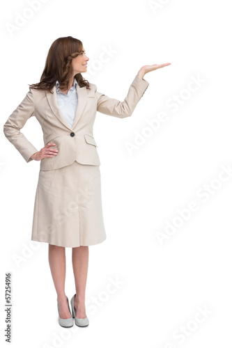 Photo: Smiling businesswoman raising her hand Smiling businesswoman raising her hand