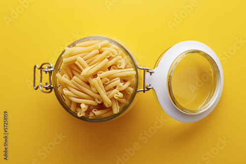 Photo: Raw strozzapreti pasta on a glass jar Raw strozzapreti pasta on a glass jar