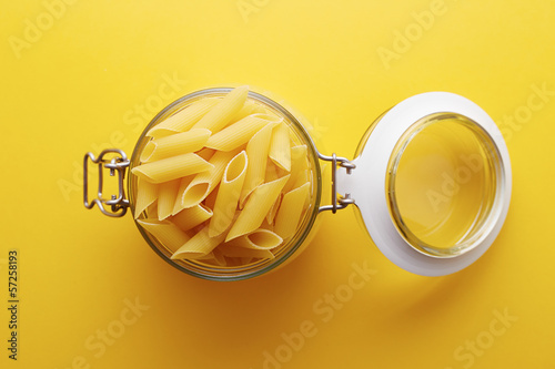 Photo: Raw pennoni rigati pasta on a glass jar Raw pennoni rigati pasta on a glass jar