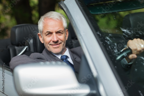 Photo: Content businessman driving expensive cabriolet Content businessman driving expensive cabriolet