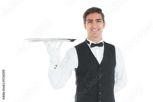 Photo: Attractive waiter presenting an empty tray Attractive waiter presenting an empty tray