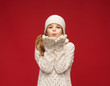 happy girl in winter clothes blowing on palms happy girl in winter clothes blowing on palms