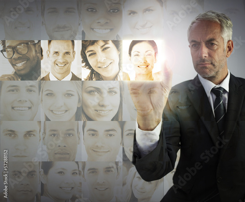 Photo: Stern businessman choosing future employees Stern businessman choosing future employees