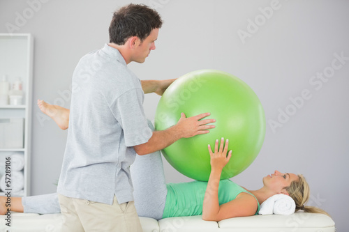 Photo: Patient training with exercise ball and physiotherapist Patient training with exercise ball and physiotherapist