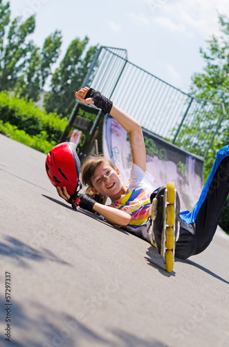Photo: Teenage rollerblader taking a fall Teenage rollerblader taking a fall