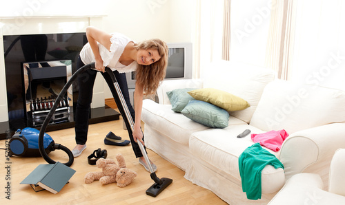 Photo: Enthusiastic woman in her chaotic living room Enthusiastic woman in her chaotic living room