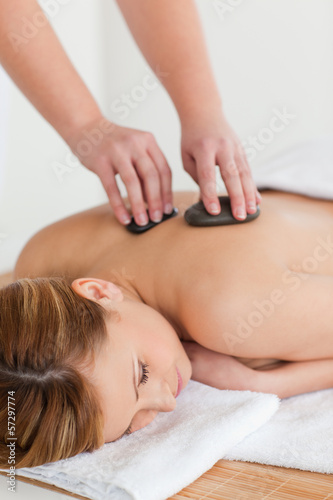 Photo: Therapist making a massage to an attractive blond-haired woman Therapist making a massage to an attractive blond-haired woman