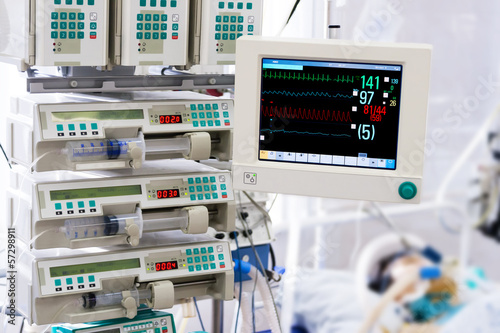 Photo: Patient with monitor and infusion pumps in an ICU Patient with monitor and infusion pumps in an ICU