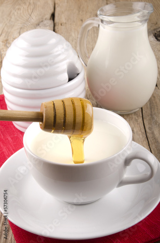 Photo: honey flows into a cup with warm milk honey flows into a cup with warm milk