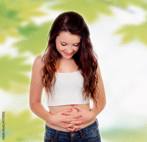 Photo: Teen woman touching her belly Teen woman touching her belly