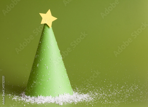 Photo: Christmas abstract paper tree on green background Christmas abstract paper tree on green background