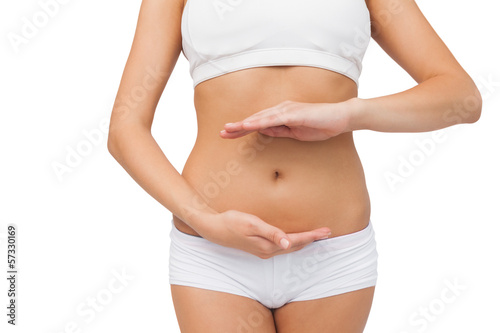 Photo: Slim woman wearing sports bra presenting with her hands Slim woman wearing sports bra presenting with her hands