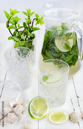 Photo: Mojito in the glass and jar, lime and cane sugar Mojito in the glass and jar, lime and cane sugar