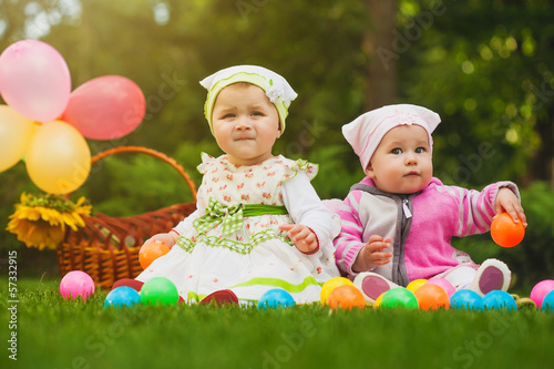 Photo: cute baby is playing on the green grass cute baby is playing on the green grass