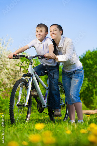 Photo: family in a green park with a bike family in a green park with a bike