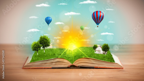 Photo: Open book with green nature world coming out of its pages Open book with green nature world coming out of its pages