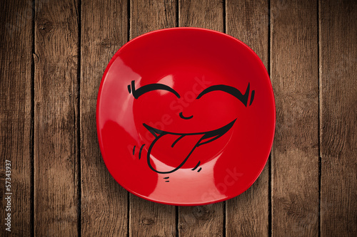 Photo: Happy smiley cartoon face on colorful dish plate Happy smiley cartoon face on colorful dish plate