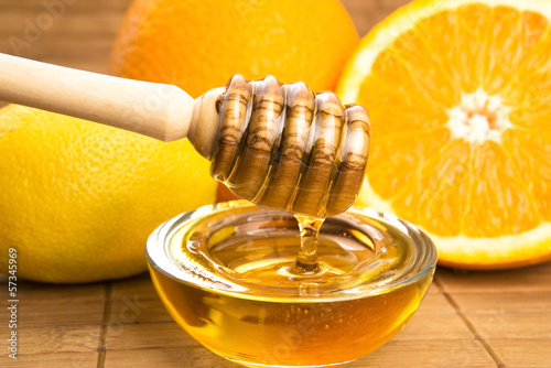 Photo: fresh honey with lemon and orange fruits fresh honey with lemon and orange fruits