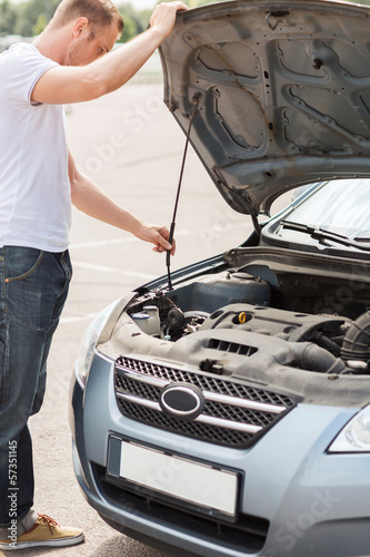 Photo: man opening car bonnet man opening car bonnet