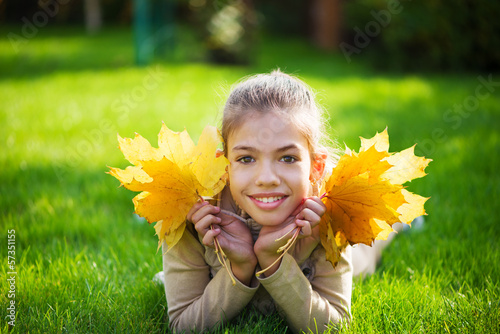 Photo: kid with maple leaves kid with maple leaves