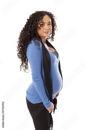 Photo: Pregnant woman's baby bump sticks out from her sweater. Pregnant woman's baby bump sticks out from her sweater.