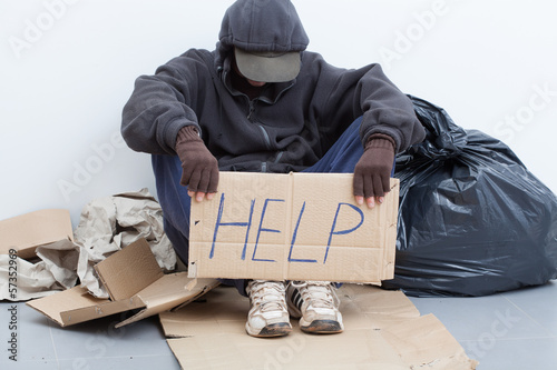 Photo: Homeless man sitting on a street Homeless man sitting on a street
