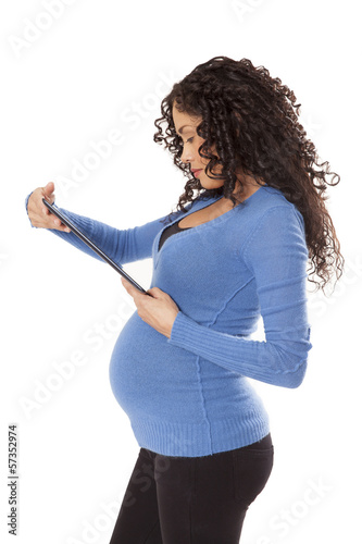 Photo: A woman in her 8th month of pregnancy uses a tablet computer. A woman in her 8th month of pregnancy uses a tablet computer.