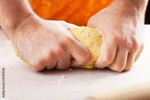 Photo: man hands kneading dough man hands kneading dough