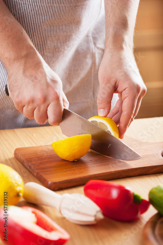 Photo: chef cutting lemon chef cutting lemon