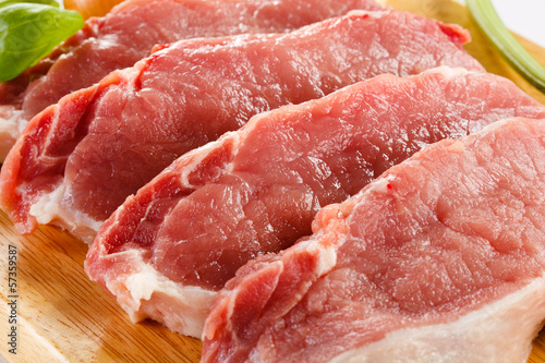 Photo: Raw pork on cutting board and vegetables Raw pork on cutting board and vegetables