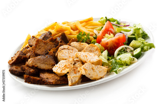 Photo: Grilled meat with French fries and vegetables Grilled meat with French fries and vegetables