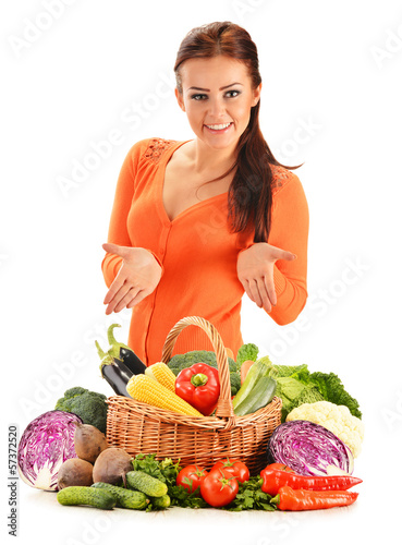 Photo: Young woman with assorted vegetables isolated on white Young woman with assorted vegetables isolated on white