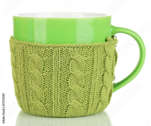 Photo: Cup with knitted thing on it isolated on white Cup with knitted thing on it isolated on white