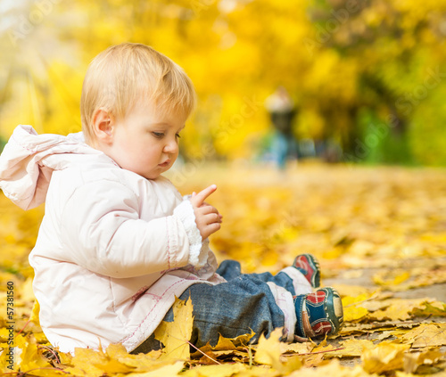 Photo: little girl among autumn leaves little girl among autumn leaves