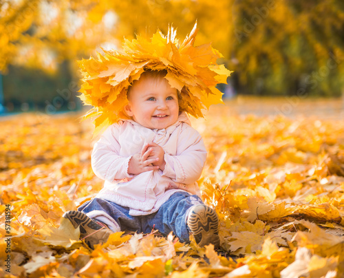 Photo: cute little girl among maple leaves cute little girl among maple leaves
