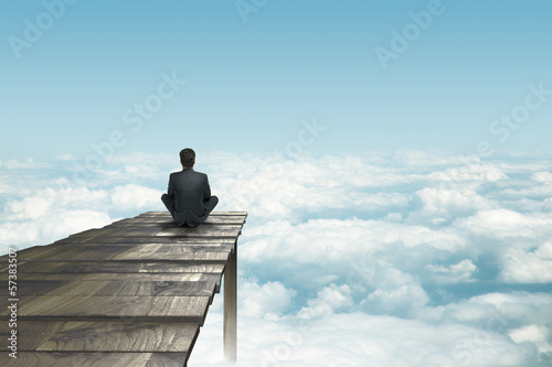 Photo: businessman sitting on pier businessman sitting on pier
