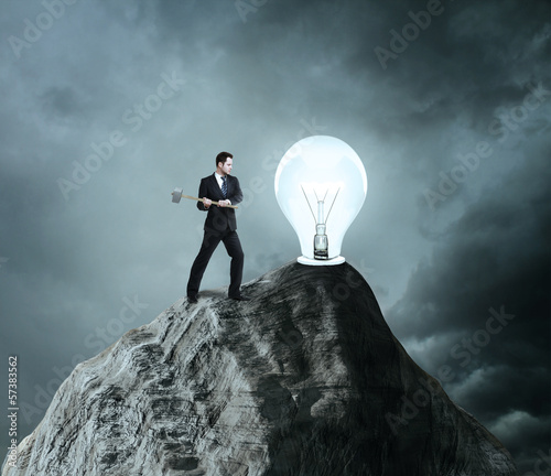 Photo: businessman breaks the light bulb businessman breaks the light bulb