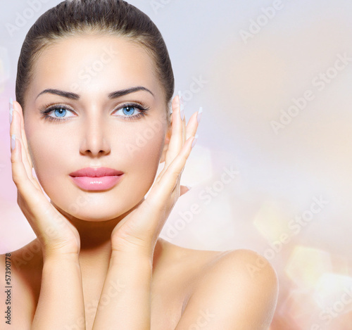 Photo: Beauty Portrait. Beautiful Spa Woman Touching her Face Beauty Portrait. Beautiful Spa Woman Touching her Face
