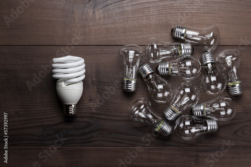 Photo: bulb uniqueness concept on the wooden table bulb uniqueness concept on the wooden table