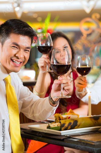 Photo: Chinese couples toasting with wine in restaurant Chinese couples toasting with wine in restaurant