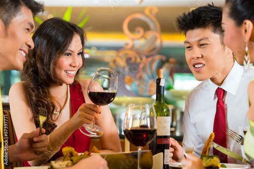 Photo: Chinese couples toasting with wine in restaurant Chinese couples toasting with wine in restaurant
