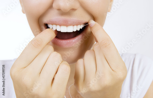 Photo: Woman and teeth floss Woman and teeth floss