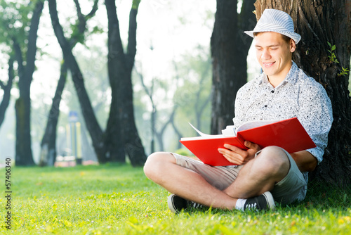 Photo: young man reading a book young man reading a book