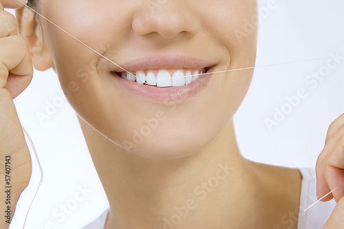 Photo: Woman and teeth floss Woman and teeth floss