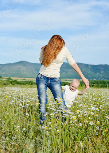 Photo: mother and son playing in field mother and son playing in field