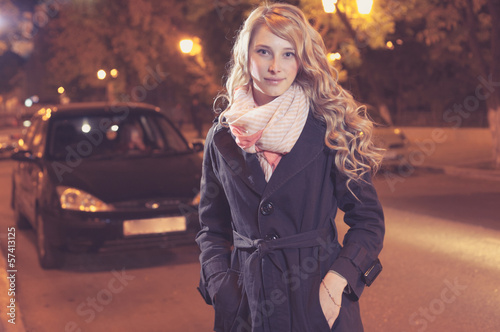 Photo: Young blond woman walking on the street Young blond woman walking on the street