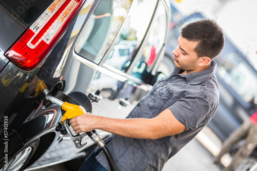 Photo: Young Man Filling His Car at Gas Station Young Man Filling His Car at Gas Station